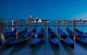 Venice, Veneto, Italy, View of San Giorgio cathedral during a quiet winter evening, with gondolas on the foreground