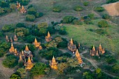 View of temples from a hot air balloon flying over Bagan, Myanmar in the early morning.
