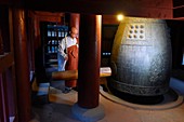 A monk calls the monks together by hitting a bell at Baekyangsa temple in Naejangsan National Park,South Korea.