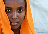 Portrait of an Oromo woman in orange veil, Amhara region, Senbete, Ethiopia.