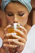Close-up of woman drinking herbal tea at home
