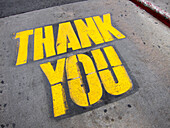 High angle view of yellow thank you text on road