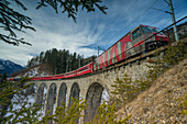 Filisur, Switzerland, The red train running away on the viaduct