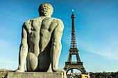 Statue of man sitting at the Trocadero and looking at the Eiffel tower, Paris, France