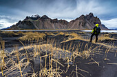 Man overlooking the landscape at Stokksnes, Eastern Iceland, Europe