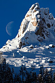 Big Moon rising in Dolomites in winter season, from Ciampedie, Val di Fassa, Province of Trento, Trentino Alto-Adige, Italy