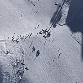 Aerial view of skiers on snow covered field