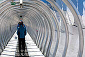 France, Eastern France, Alps, moving walkway of the ridges, skier wearing an anorak, seen from the back