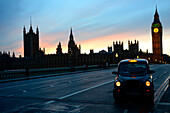 United Kingdom, London, a taxi in the foreground, Big Ben and the Parliament from Westminster Bridge in the background