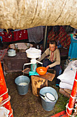 Kyrgyzstan, Issyk Kul Province (Ysyk-Kol), Juuku valley, Ouloukbek the eldest son skims the cow milk