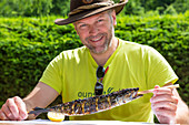 Fish on a stick called Steckerlfisch, speciality around Bad Ischl, Salzkammergut, Upper Austria, Austria, Europe