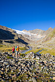 A man and a woman hiking, Sulzenautal and Sulzenau Glacier, Stubai Valley Trail, Stubaital, Tyrol, Austria, Europe