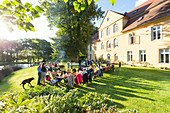 Garden party, guests having dinner at long table, event dinner at the caste Lühburg, Mecklenburg lakes, Mecklenburg lake district, Lühburg, Mecklenburg-West Pomerania, Germany, Europe