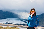 Portrait Of A Smiling Woman In Front Of A Glacier