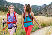 Portrait Of Two Female Hiker Smiling While Hiking On Trail In Colorado