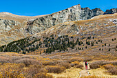 Female Hiker Hiking On A Trail Beneath Mount Bierstadt In Colorado