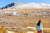 Female Hiker Standing On Desert Landscape Beneath Mount Bierstadt In Colorado