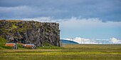 Two Sheep Huts Built Near A Cliff At Hnappavellir