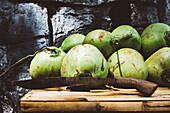 Stack Of Coconuts With Machete