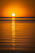 Orange sunset over the water in Belize