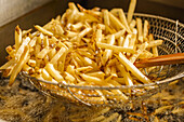 Stack Of Fries In A Fryer Basket