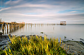 Soft light of dawn on the Palafito Pier, Carrasqueira Natural Reserve of Sado River, Alcacer do Sal, Setubal, Portugal, Europe