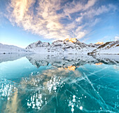 Panorama of ice bubbles and frozen surface of Lago Bianco at dawn, Bernina Pass, canton of Graubunden, Engadine, Switzerland, Europe