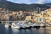 Pastel hues of the glamorous harbour of Monaco (Port Hercules) with many yachts, view from the sea, Monte Carlo, Monaco, Cote d'Azur, Mediterranean, Europe