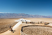 Tourist Walking On Badwater Basin In Death Valley National Park, California, Usa