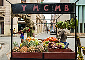 'Two men pull a fruit cart down a street in Old Havana. The sign above the cart reads YMCMB''.  La Habana Veija, La Habana, Cuba'''