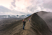 Hikers Taking Picture Standing On Top Of Mountain Near Geothermal