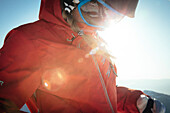 A woman preparing to ski in the early morning light of Snowbird, Utah.