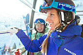 A woman smiling and happy as she rides the Snowbird tram.
