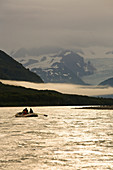 Rafters rafting down the Tatshenshini river, Alaska. The Tatshenshini is one of the wildest and most spectacular rivers in North America, flowing past tall mountains, glaciers, and icebergs. Wildlife is abundant including bald eagles and grizzly bears. Th