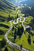 Aerial view of the road up to Passo Pordoi (2239 m), the second pass of the Maratona dles Dolomites bikerace. The race is held once a year in July with up to 8500 cyclists competing, from amateurs to professionals. Dolomites, Italy.
