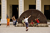Havana, Cuba - A pickup baseball game around the tourists and art in the old square, Plaza Vieja, Old Havana