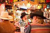 A bartender chats with patrons at the Cowgirl BBQ restaurant in Santa Fe, New Mexico, on Dec. 21, 2013.
