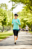 Young Woman Running On Street Of The Esplanade Near Charles River