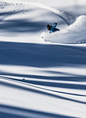 Snowboarder Makes A Turn And Sprays Powder Into The Air After A Storm