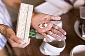 Woman Hand Holding Clay Brick In Ceramic Workshop