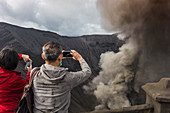 Hikers Standing On Top Of The Mountain And Taking A Pictures Of Geothermal In Java, Indonesia