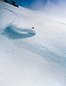 A Female Snowboarder Makes A Turn In Deep Snow At Cerro Catedral, Argentina