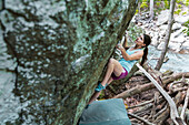 Female Athlete Climbing On Boulder Outside By The River In Maryland