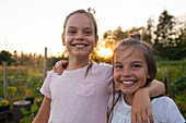 Portrait Of Two Sisters Laughing In The Garden In Fort Langley