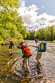 Hikers Ford The Pleasant River While Hiking On The Appalachian Trail