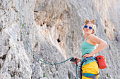 A Woman With Cat Ears Pout At The Camera While Rock Climbing