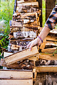 Close-up Of Woman Hand Holding Firewood