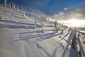 Ski Lift At Snowy Landscape During Sunrise In Whitefish, Montana, Usa