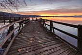 Winter sunrise on the Gavirate pier of Lago di Varese, Varese Province, Lombardy, Italy