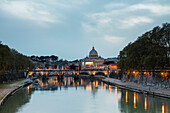 Dusk lights on Tiber River with bridge Umberto I and Basilica di San Pietro in the background Rome Lazio Italy Europe